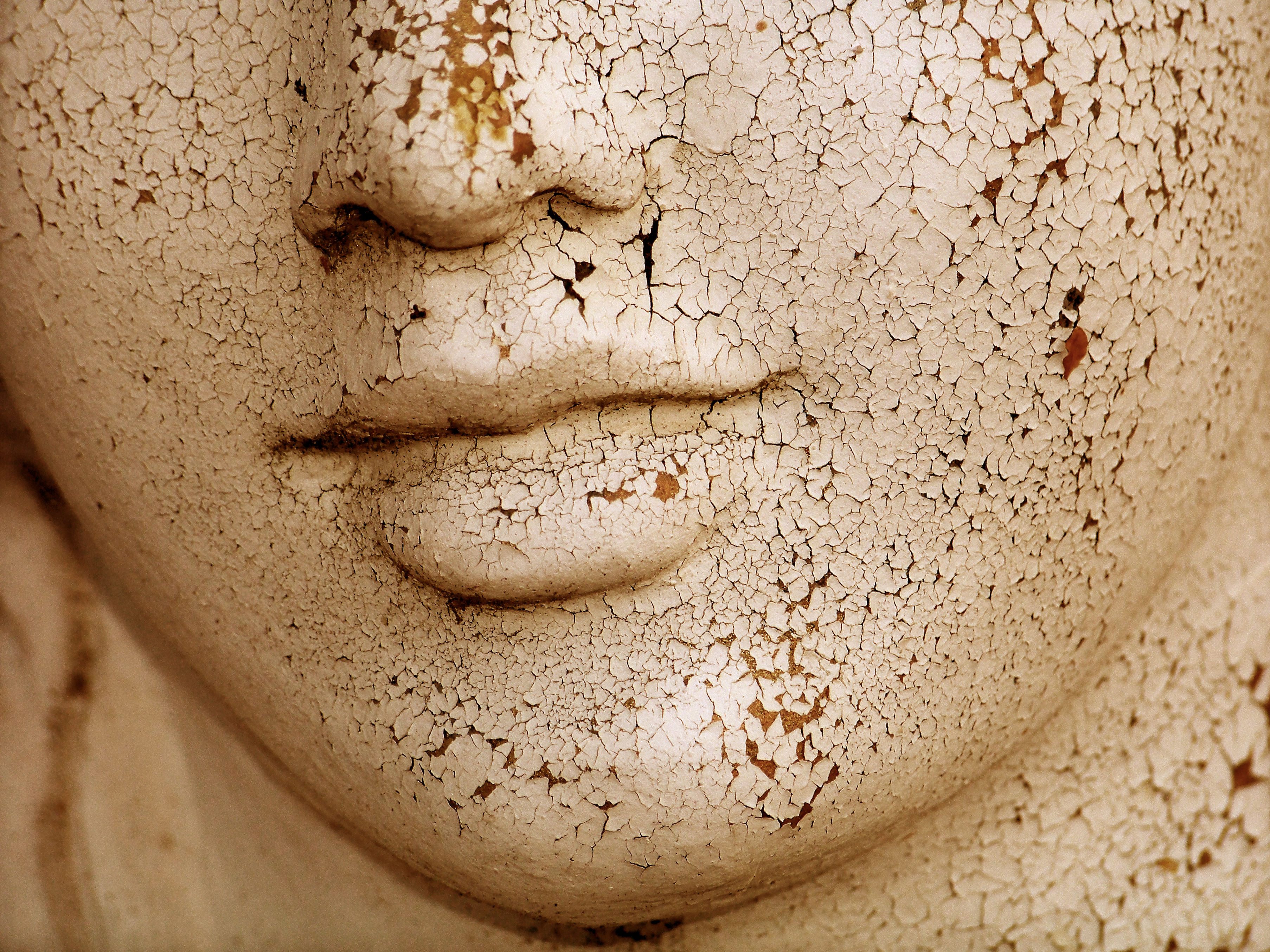 51448039 - dried skin cracked woman sculptural face close up